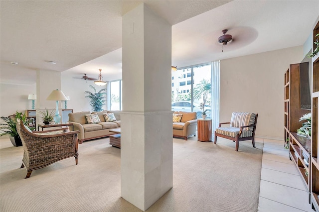 carpeted living room with ceiling fan