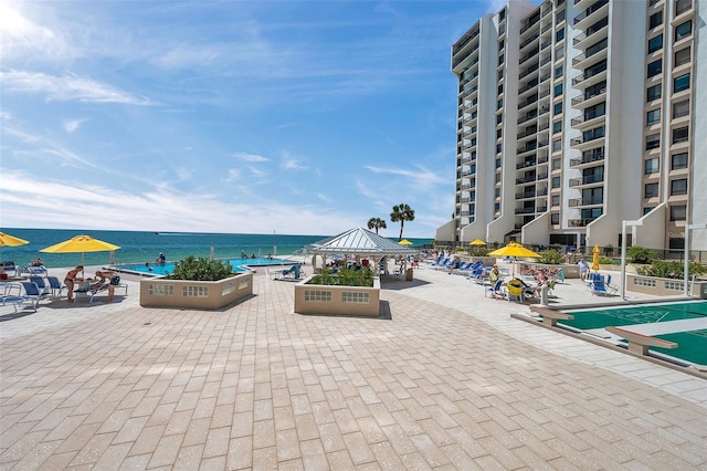 view of patio with a water view and a balcony