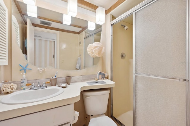 bathroom with vanity with extensive cabinet space, an enclosed shower, and toilet