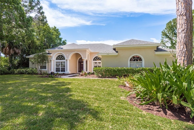 mediterranean / spanish-style house with a front lawn