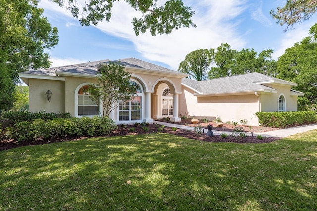 mediterranean / spanish-style home featuring a front yard