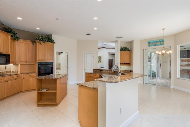 kitchen featuring light tile floors, sink, hanging light fixtures, black appliances, and kitchen peninsula