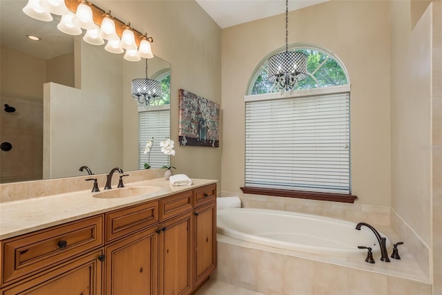 bathroom featuring vanity and tiled bath