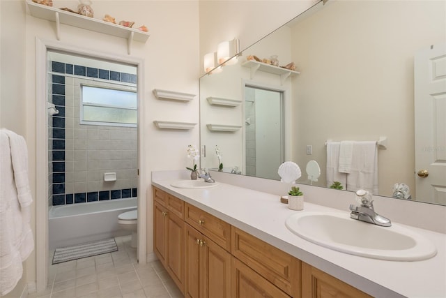 full bathroom featuring oversized vanity, toilet, tiled shower / bath combo, tile floors, and dual sinks