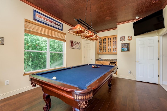 rec room with bar, ornamental molding, dark hardwood / wood-style floors, and pool table