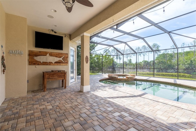 view of swimming pool featuring a patio, ceiling fan, a lanai, and an in ground hot tub