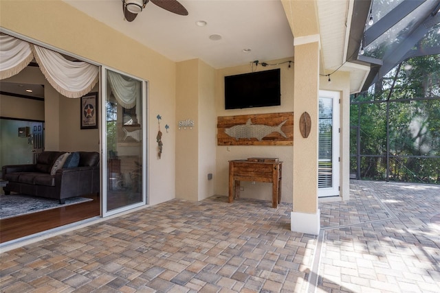 view of terrace with ceiling fan and a lanai