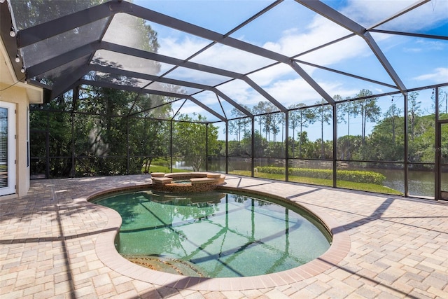 view of swimming pool featuring glass enclosure, an in ground hot tub, and a patio area