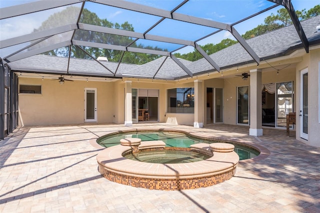 view of swimming pool with a patio area, ceiling fan, an in ground hot tub, and a lanai