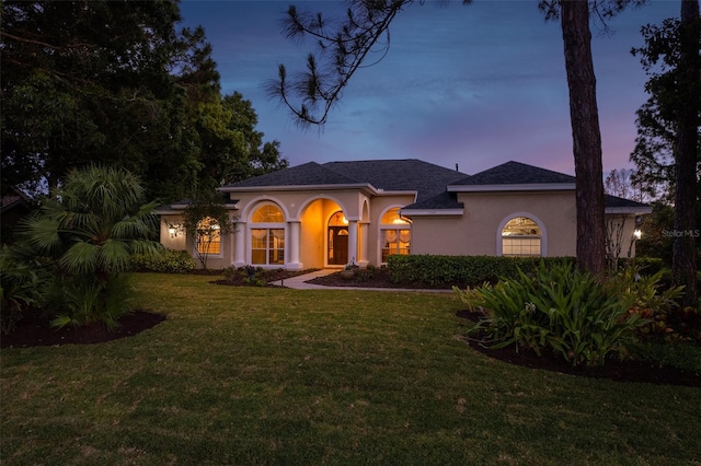 mediterranean / spanish house with a lawn