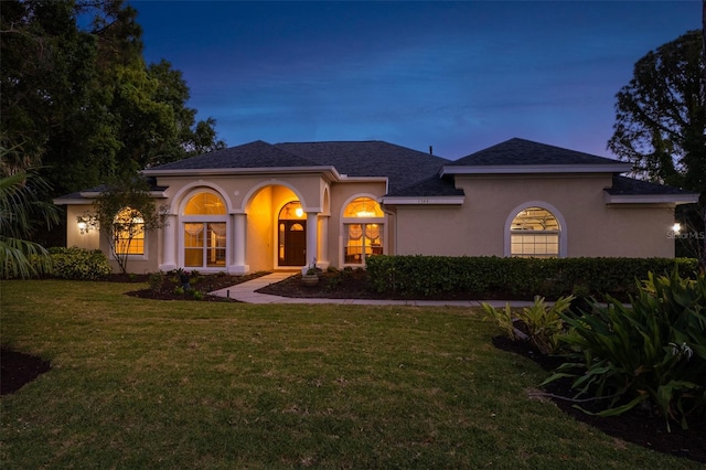 mediterranean / spanish-style home featuring a lawn