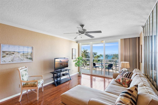 living room featuring hardwood / wood-style flooring, floor to ceiling windows, ornamental molding, and ceiling fan