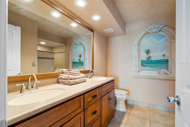 bathroom featuring tile patterned flooring, vanity, and toilet