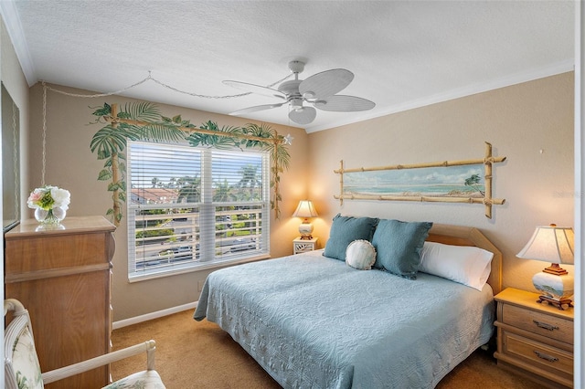 bedroom featuring ceiling fan, carpet, a textured ceiling, and ornamental molding