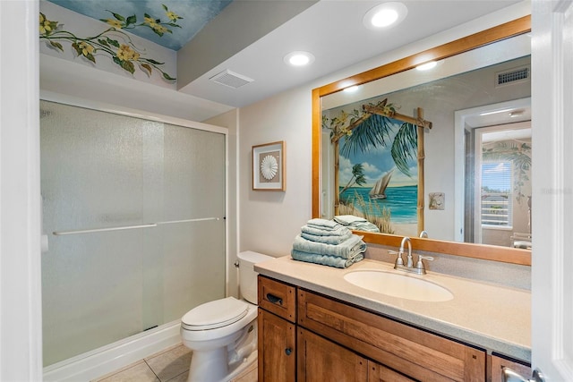 bathroom featuring tile patterned floors, vanity, toilet, and an enclosed shower