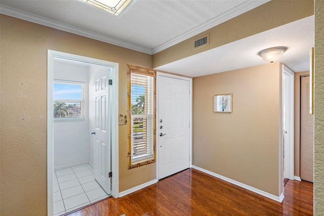 entryway with crown molding and wood-type flooring