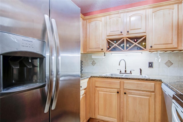 kitchen featuring backsplash, stainless steel fridge with ice dispenser, light brown cabinets, and sink