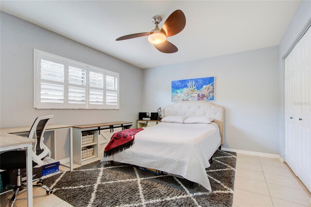 tiled bedroom with a closet and ceiling fan