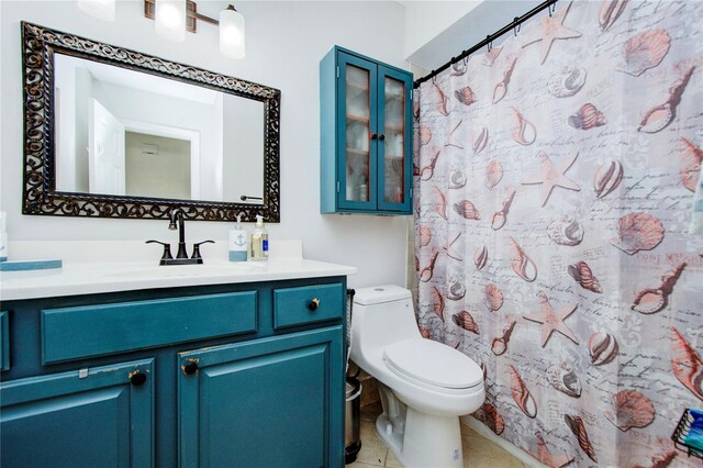 bathroom with tile flooring, vanity, and toilet