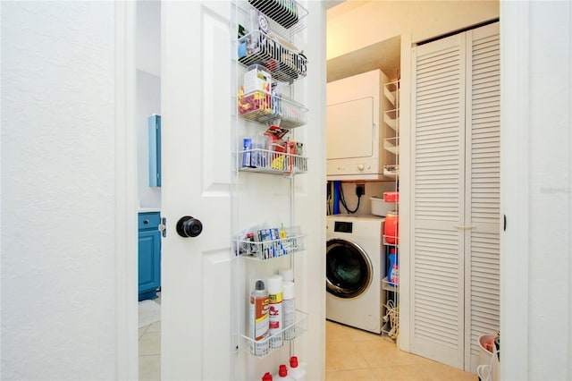 washroom featuring hookup for an electric dryer, stacked washer and dryer, and light tile floors