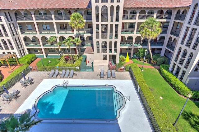 view of swimming pool with a patio and a yard