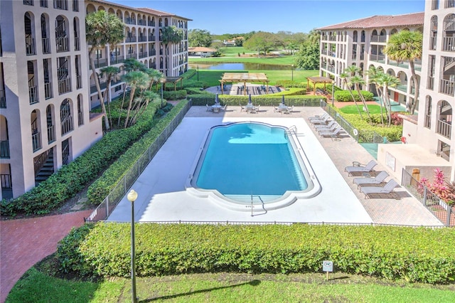 view of pool featuring a patio area and a lawn