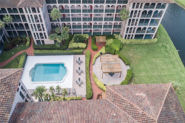 view of pool featuring a patio area and a lawn