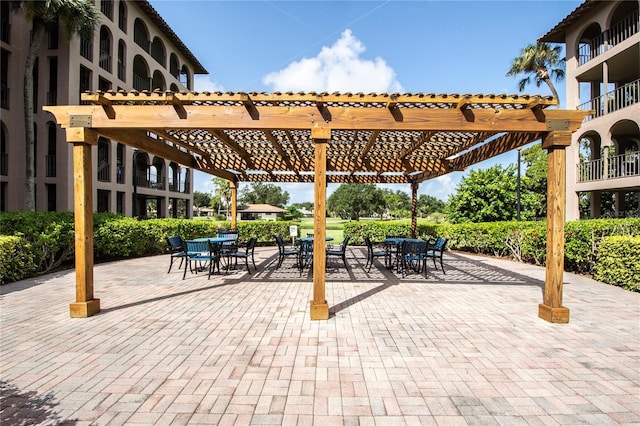 view of terrace featuring a balcony and a pergola