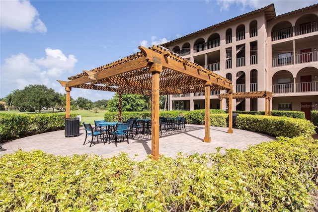 view of property's community with a patio and a pergola