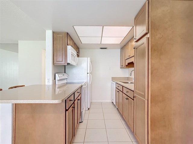 kitchen with white appliances, sink, and light tile patterned floors