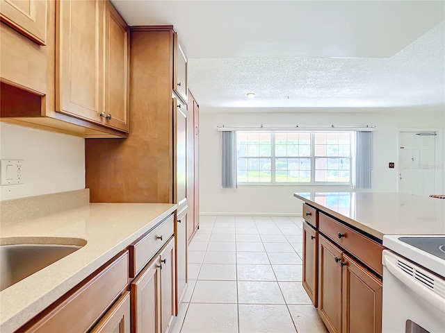 kitchen featuring light tile patterned floors and a textured ceiling