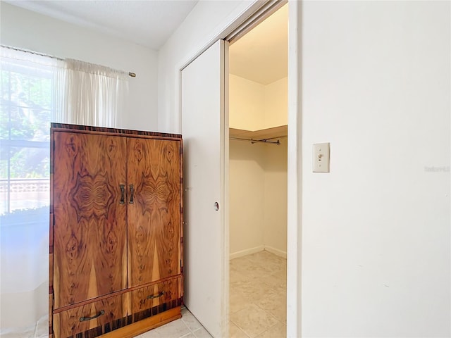 interior space featuring light tile patterned floors and baseboards