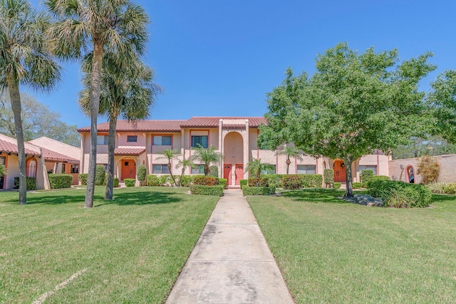 mediterranean / spanish-style home with a front lawn