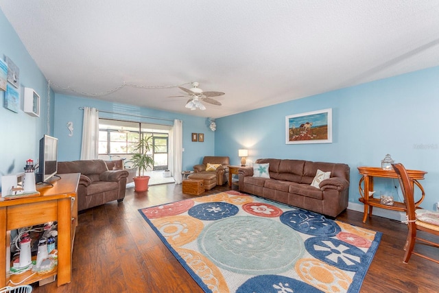 living room featuring dark hardwood / wood-style flooring and ceiling fan