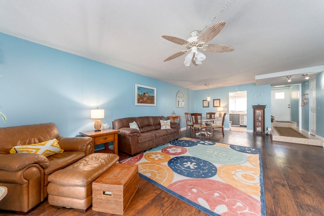 living room featuring dark hardwood / wood-style flooring and ceiling fan