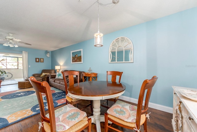 dining room featuring a textured ceiling, dark hardwood / wood-style flooring, and ceiling fan