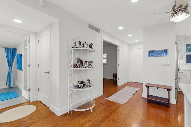 corridor with hardwood / wood-style flooring