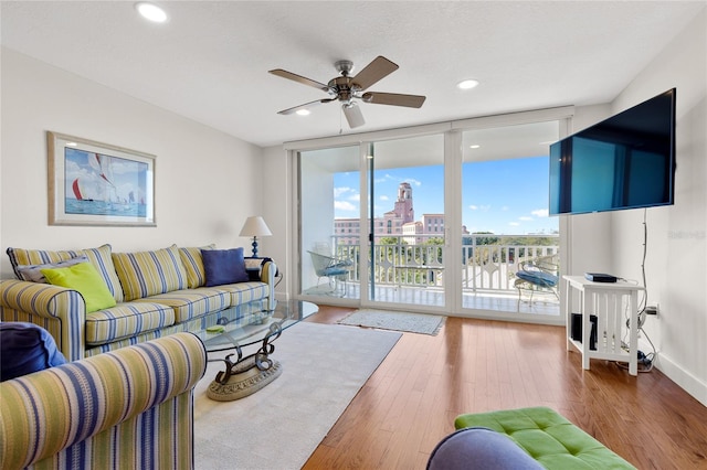 living room with wood-type flooring and ceiling fan