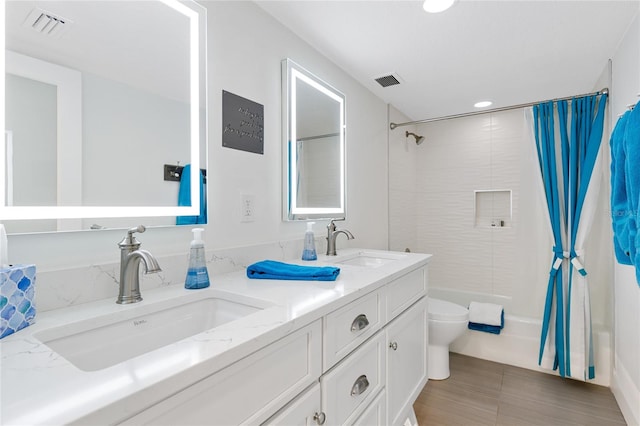 full bathroom featuring tile flooring, large vanity, double sink, toilet, and shower / bathtub combination with curtain