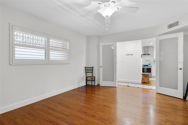 spare room featuring light hardwood / wood-style floors and ceiling fan