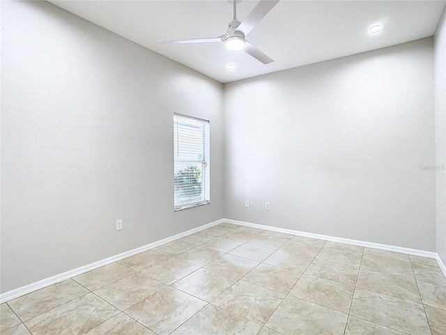 tiled spare room with ceiling fan