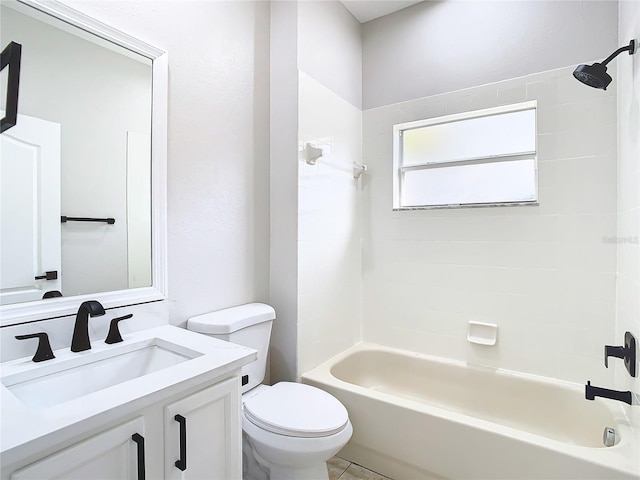 full bathroom featuring tile floors, vanity, tiled shower / bath combo, and toilet