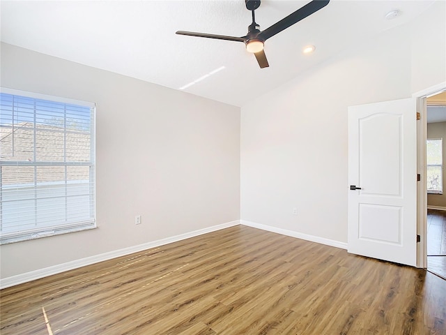 unfurnished room featuring dark hardwood / wood-style flooring, ceiling fan, and vaulted ceiling