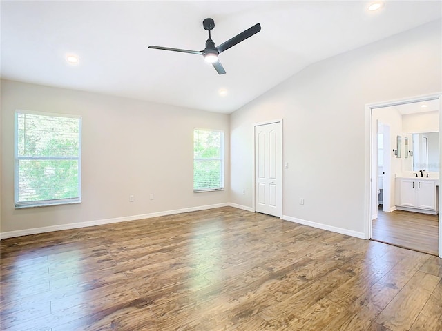 unfurnished bedroom with dark hardwood / wood-style floors, ceiling fan, lofted ceiling, and multiple windows