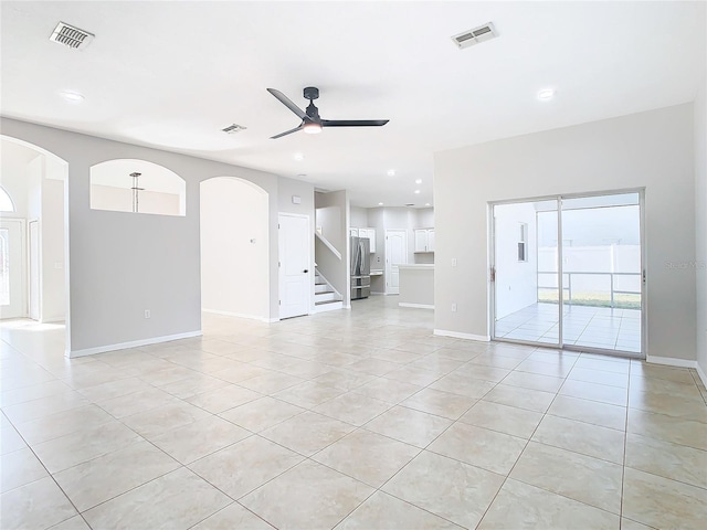 unfurnished living room with ceiling fan and light tile floors