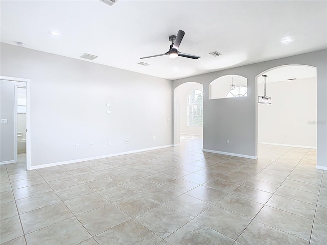 spare room featuring ceiling fan and light tile floors