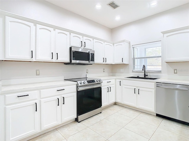 kitchen featuring white cabinets, sink, and appliances with stainless steel finishes