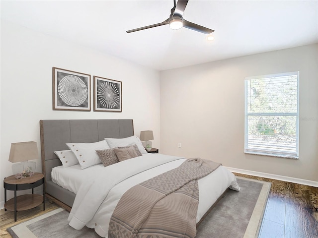 bedroom with ceiling fan and hardwood / wood-style flooring