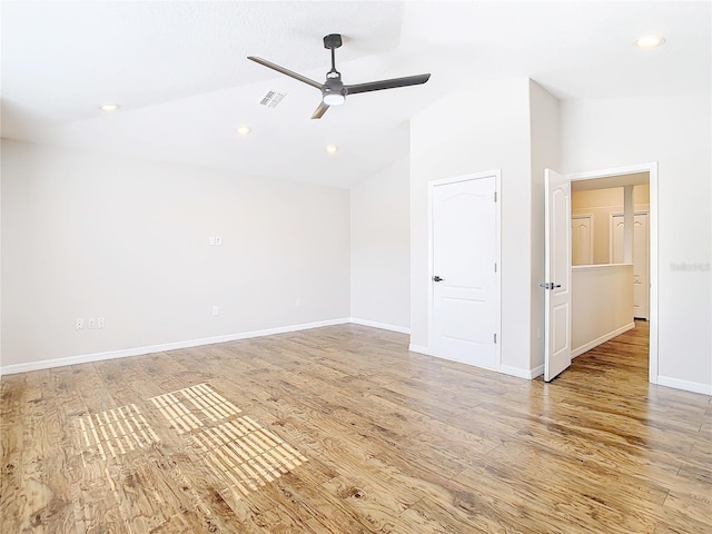 empty room with high vaulted ceiling, light hardwood / wood-style floors, and ceiling fan