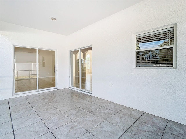 spare room featuring light tile floors